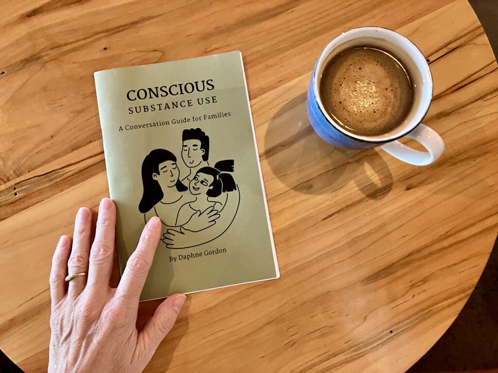 A photo shows a booklet called Conscious Substance Use: A Conversation Guide for Families. A hand and a coffee cup are also shown.